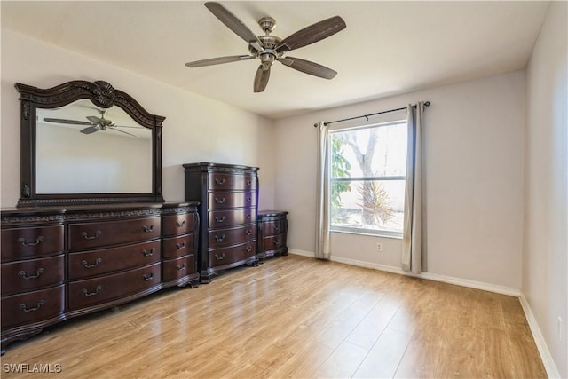 bedroom with light wood-type flooring, baseboards, and ceiling fan