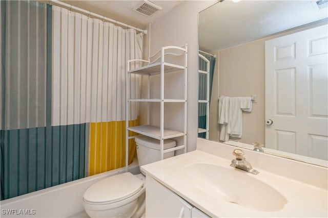 bathroom featuring visible vents, vanity, toilet, and shower / tub combo with curtain