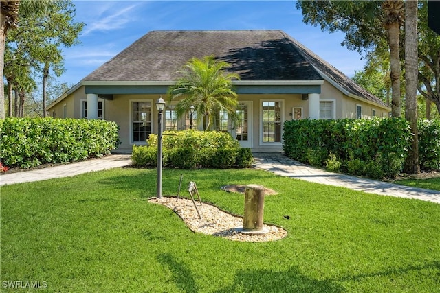 view of front of property with stucco siding and a front yard