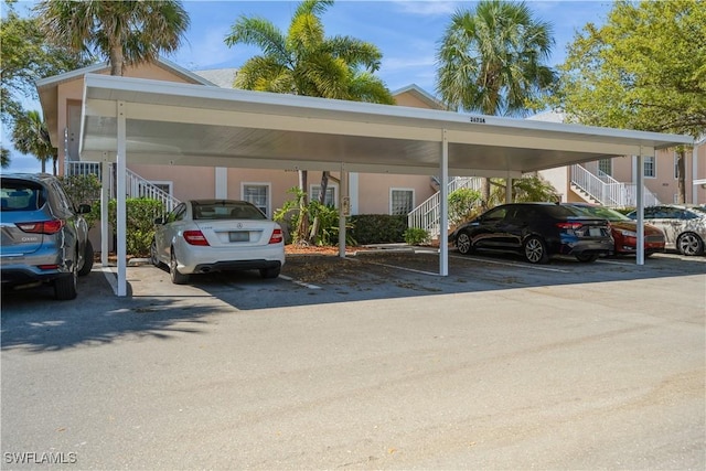 partially covered parking lot featuring stairway