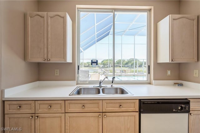 kitchen featuring a sink, light brown cabinets, white dishwasher, and light countertops