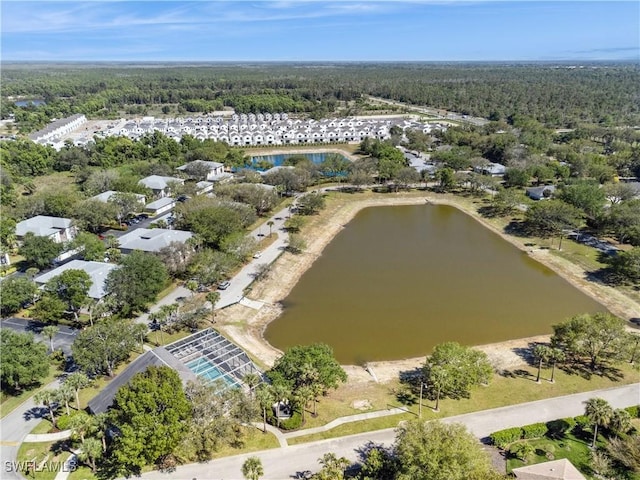 drone / aerial view with a view of trees and a water view