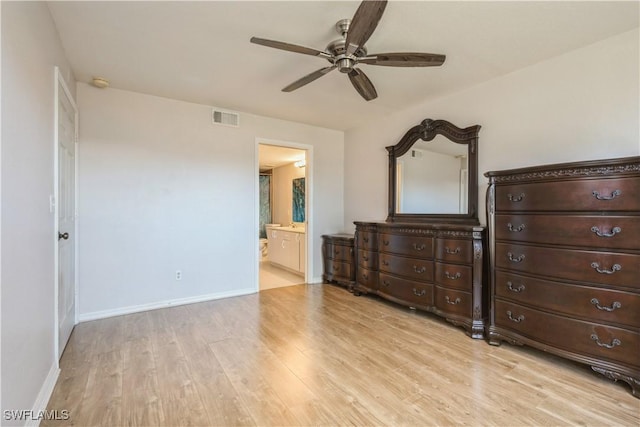 bedroom with visible vents, baseboards, light wood-style floors, ensuite bath, and a ceiling fan