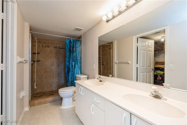 full bath with visible vents, a shower stall, toilet, and a sink