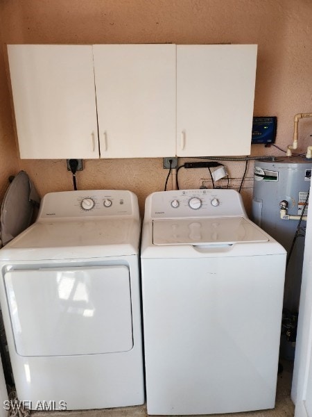 clothes washing area featuring cabinet space and washing machine and clothes dryer