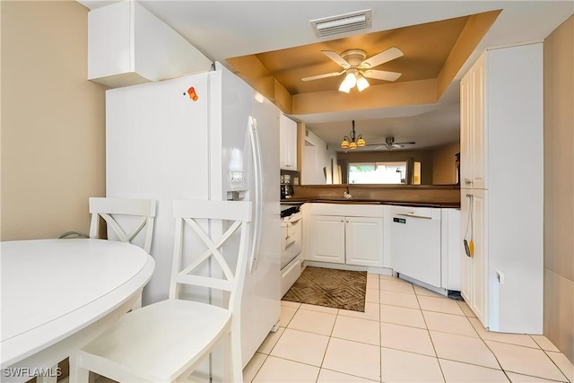 kitchen featuring dark countertops, visible vents, ceiling fan, light tile patterned flooring, and white appliances