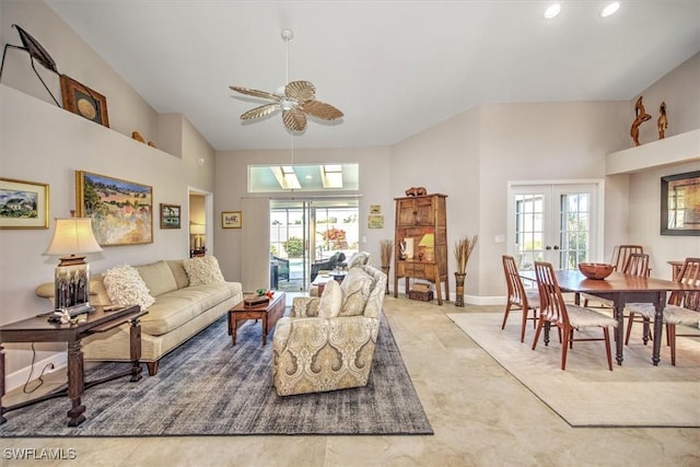 living area with a high ceiling, plenty of natural light, and a ceiling fan