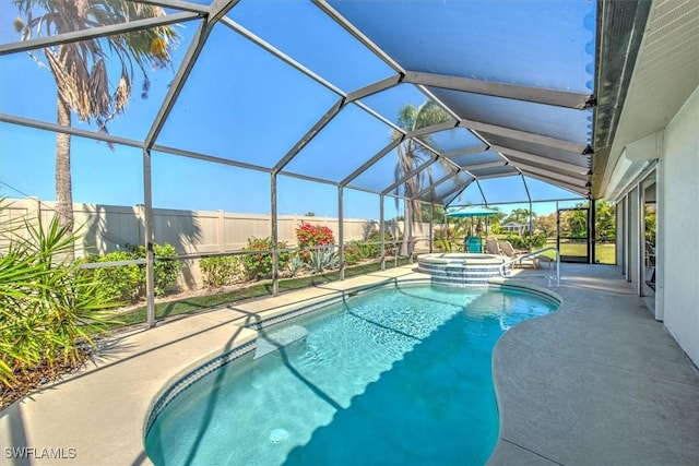 12488 Kelly Pine Ct, Fort Myers, FL 33908 - view of swimming pool with glass enclosure, a patio area, fence, and a pool with connected hot tub