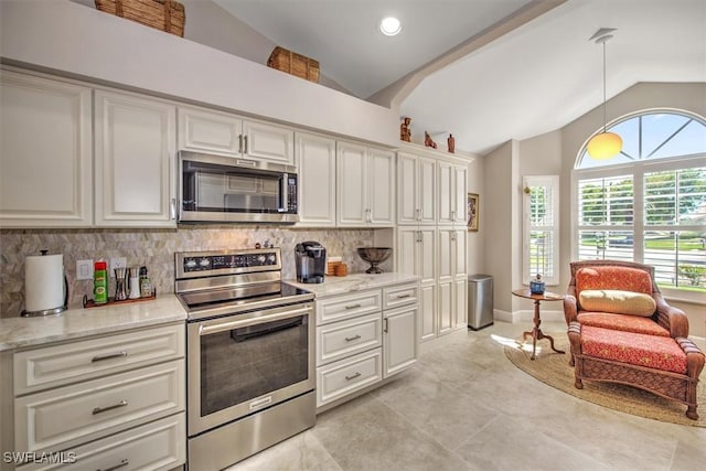 12488 Kelly Pine Ct, Fort Myers, FL 33908 - kitchen with decorative backsplash, white cabinets, appliances with stainless steel finishes, and lofted ceiling