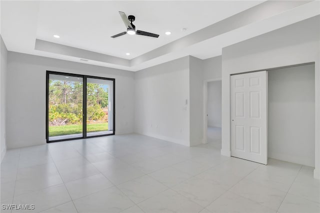 unfurnished room with ceiling fan, a tray ceiling, and recessed lighting