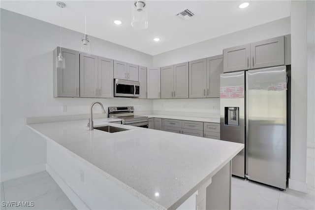 kitchen featuring visible vents, marble finish floor, stainless steel appliances, gray cabinetry, and a sink