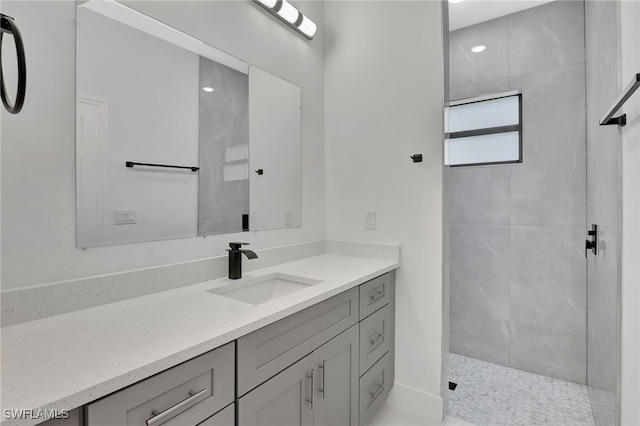 bathroom with walk in shower and vanity