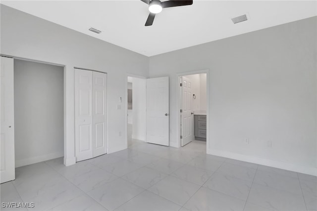 unfurnished bedroom with marble finish floor, visible vents, and baseboards