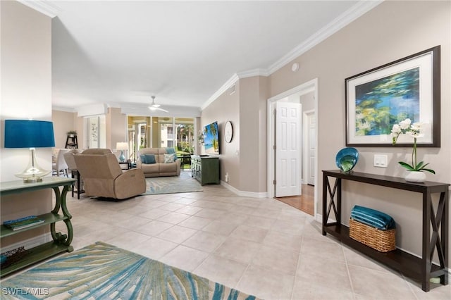 living room with ornamental molding, ceiling fan, baseboards, and light tile patterned floors