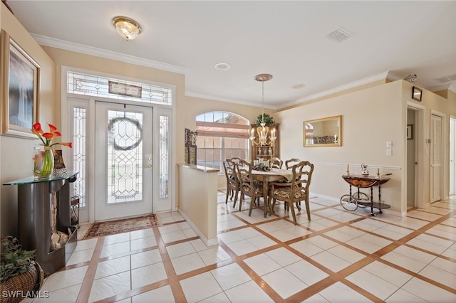 foyer with crown molding, visible vents, and baseboards