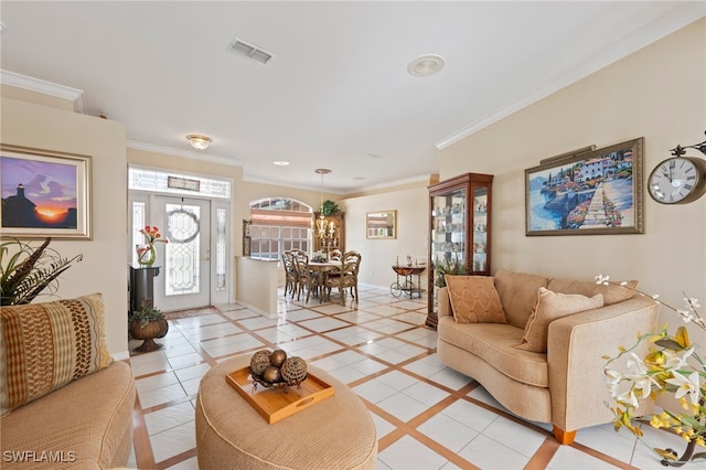 living room with ornamental molding, visible vents, and baseboards