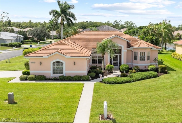 view of front of property featuring a tiled roof and a front lawn