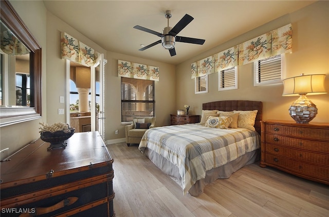 bedroom with a ceiling fan, baseboards, decorative columns, and light wood finished floors