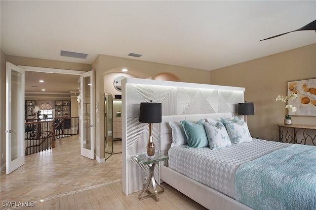 bedroom featuring light wood finished floors, french doors, visible vents, and baseboards