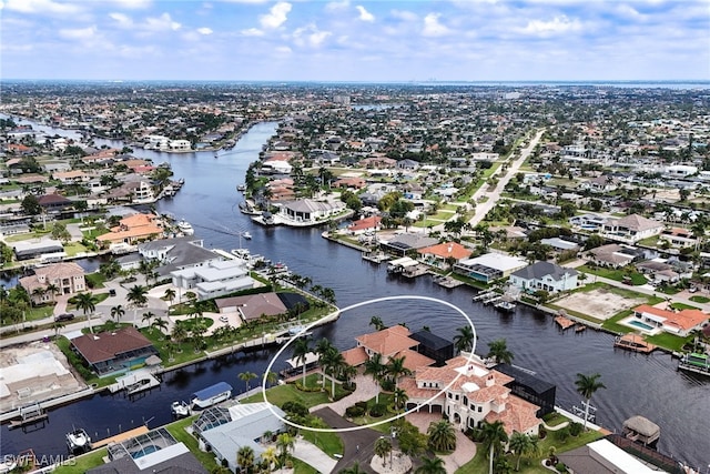 drone / aerial view with a residential view and a water view