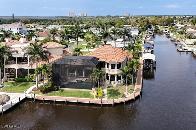 birds eye view of property with a water view and a residential view