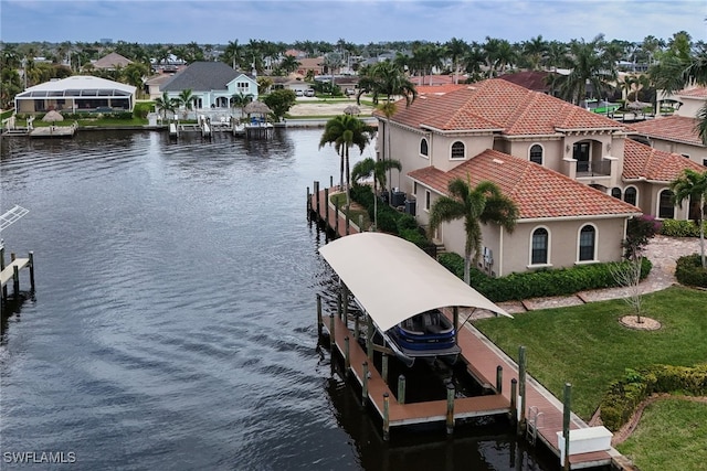 view of dock with a residential view, a water view, a yard, and boat lift