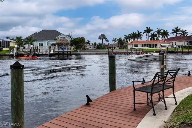 view of dock with a water view and a residential view