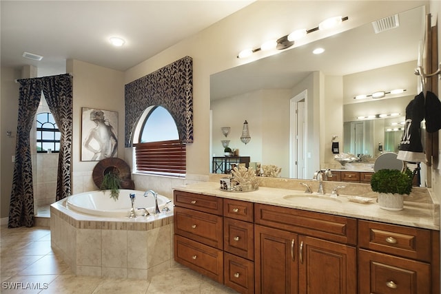 bathroom featuring visible vents, a garden tub, vanity, and tile patterned floors