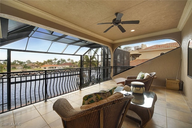 view of patio with a water view, a lanai, and a ceiling fan