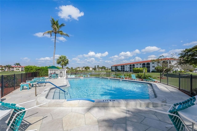 community pool featuring a patio area and fence