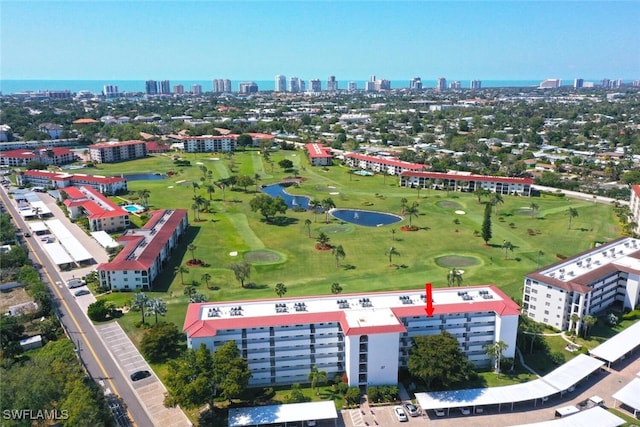 aerial view featuring a water view, a city view, and golf course view