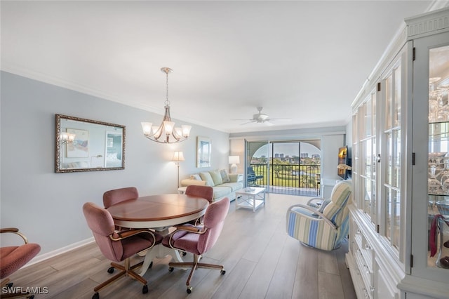 dining room with crown molding, baseboards, ceiling fan with notable chandelier, and wood finished floors