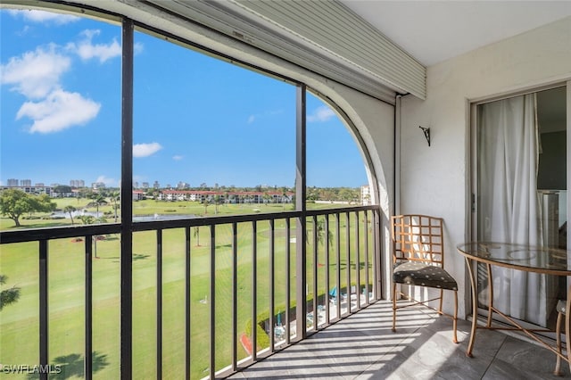 sunroom featuring a water view