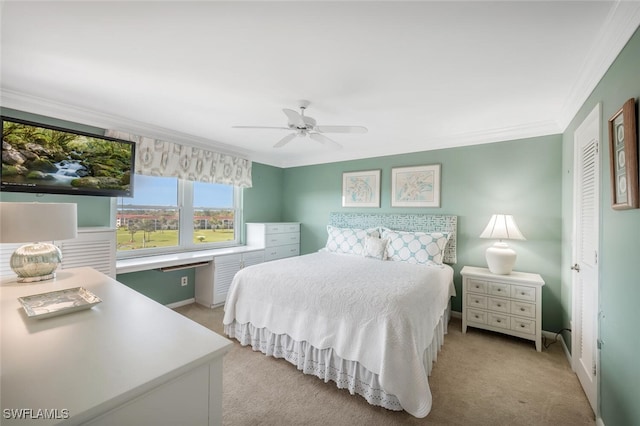 bedroom featuring crown molding, baseboards, a ceiling fan, and light colored carpet