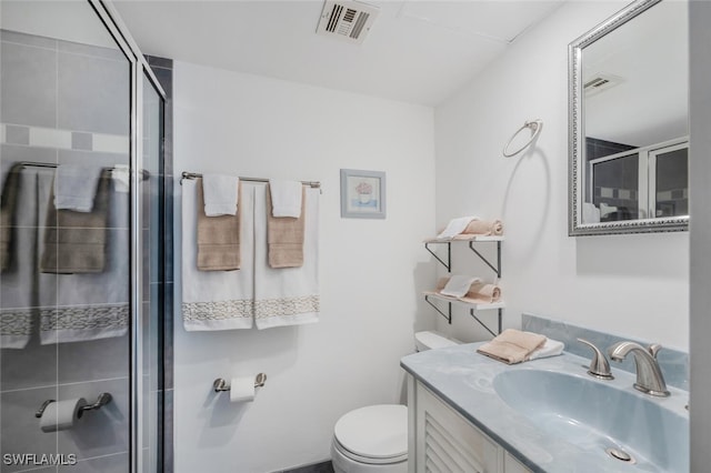 full bathroom with visible vents, vanity, toilet, and a shower stall
