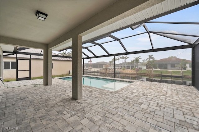 pool featuring glass enclosure and a patio area