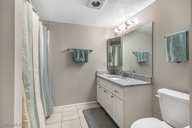 full bathroom featuring baseboards, toilet, tile patterned floors, a textured ceiling, and vanity