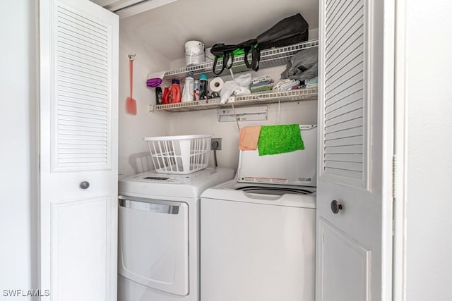 clothes washing area with laundry area and washer and dryer