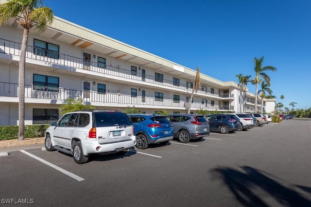 view of building exterior featuring uncovered parking