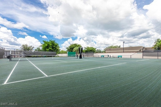 view of tennis court with fence