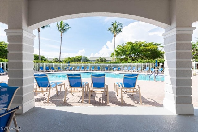 community pool featuring a patio area and fence