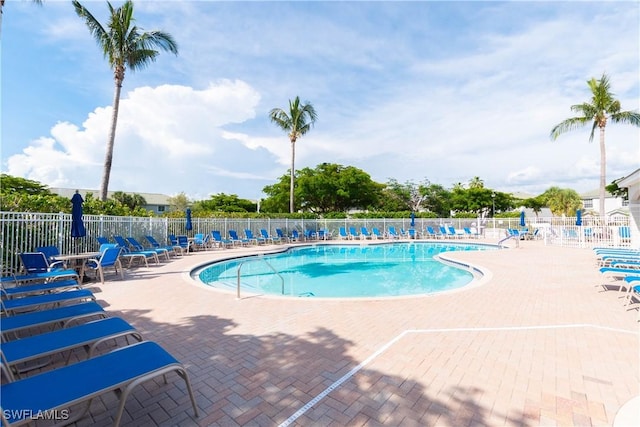 community pool featuring a patio area and fence