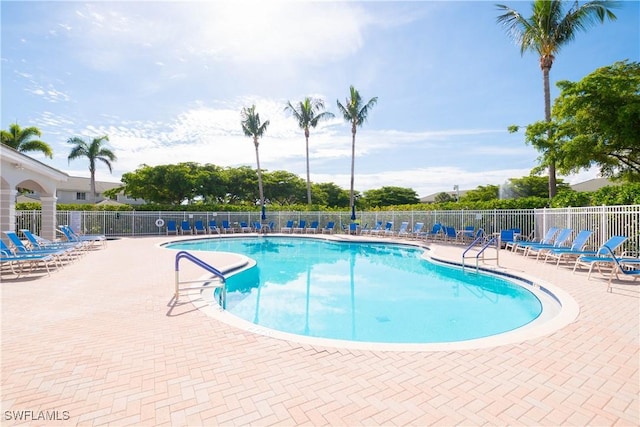 community pool featuring a patio and fence