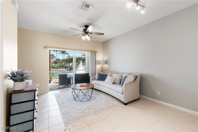 living room with visible vents, baseboards, light tile patterned flooring, and a ceiling fan