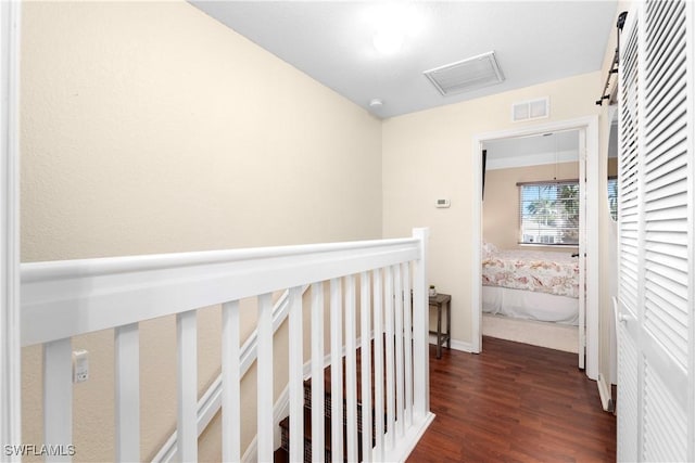 corridor with visible vents and wood finished floors