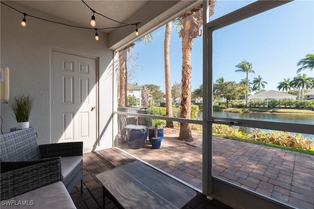 exterior space with a water view and a patio