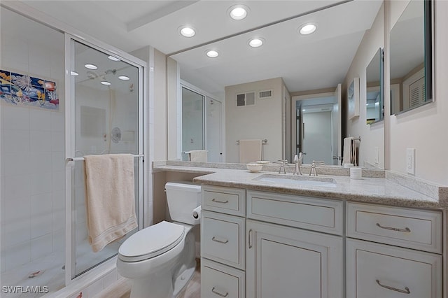 full bathroom with visible vents, toilet, a stall shower, and vanity