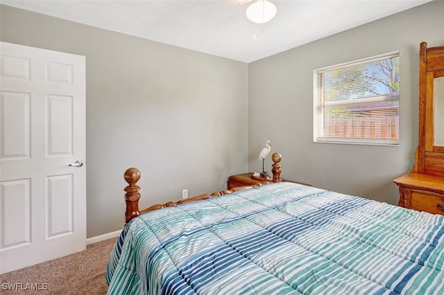 carpeted bedroom featuring baseboards