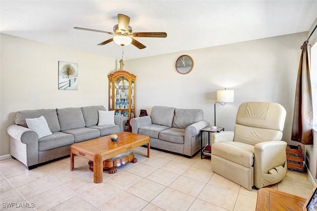 living room featuring light tile patterned flooring, a ceiling fan, and baseboards