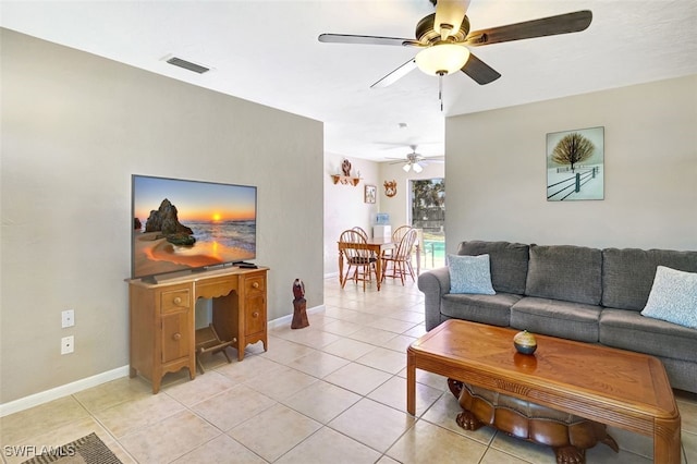 living room featuring visible vents, ceiling fan, baseboards, and light tile patterned floors